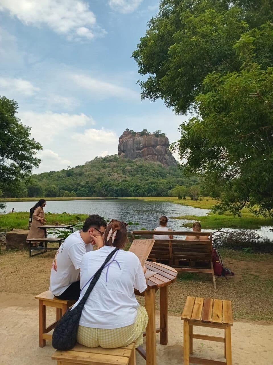 Sigiriya Lion Rock seen across a calm lake