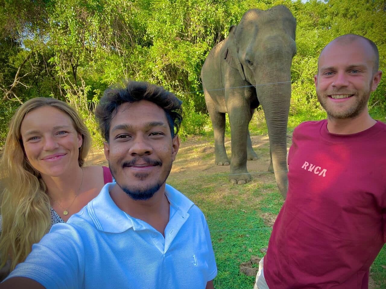 Our guide with guests and an elephant
