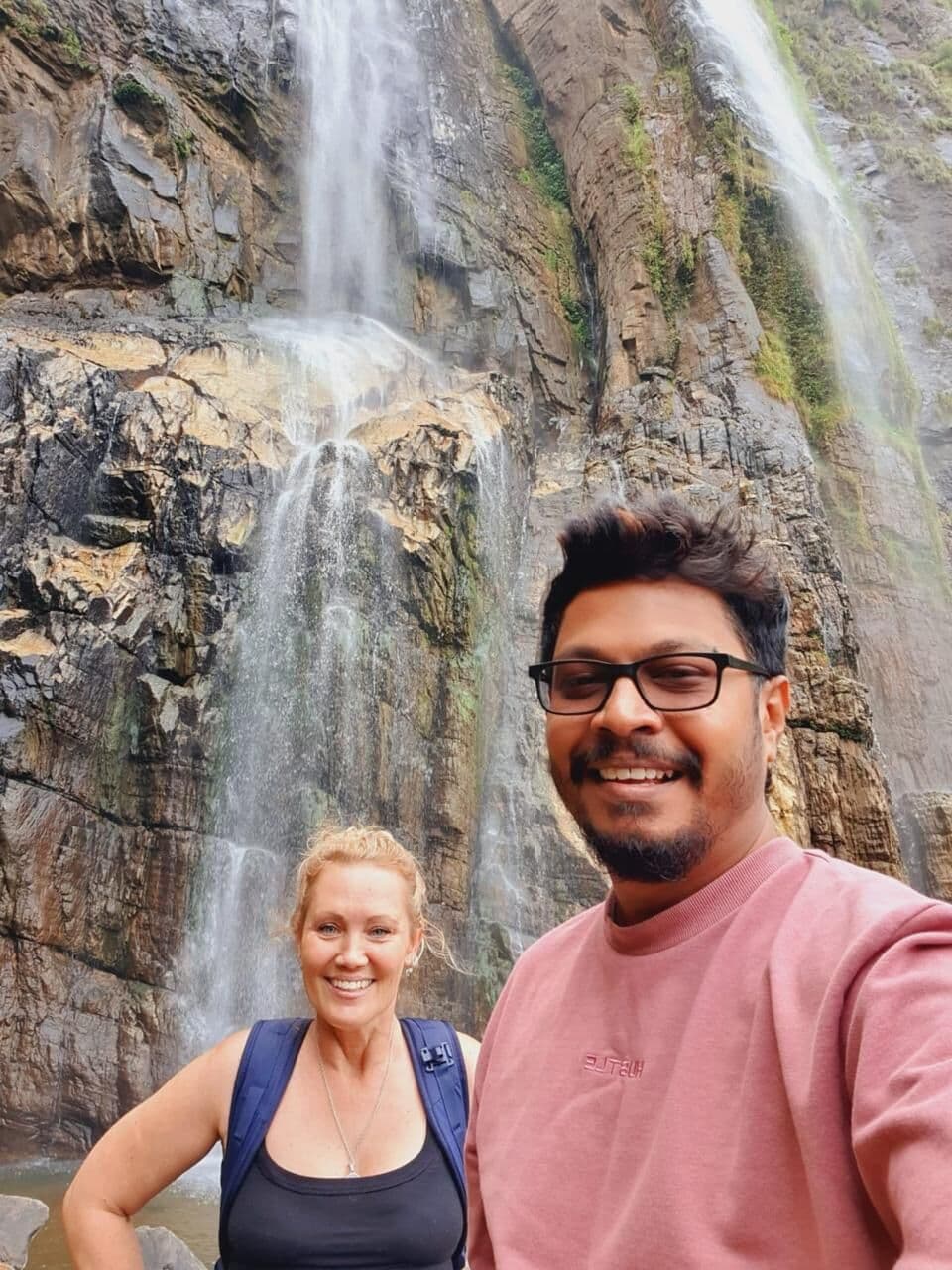 Our guide with a guest at a waterfall near Ella