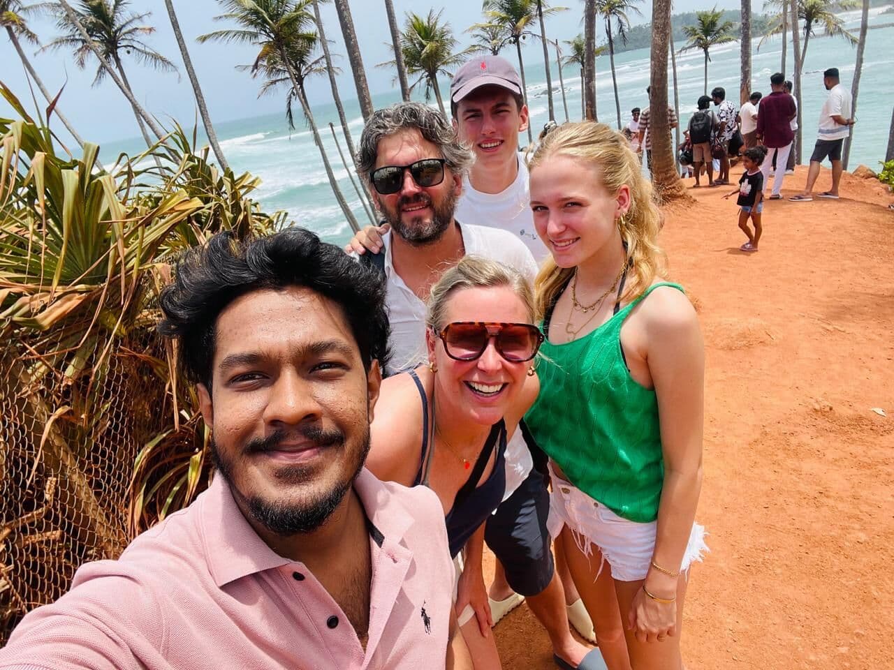 Our guide with a group of guests by the sea